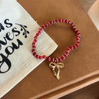 “More Precious Than Rubies” Handmade Glass Bead Stretch Bracelet with Bow Charm