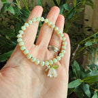 “Consider the Lillies” Handmade Glass Bead Stretch Bracelet with Flower and Mini Cross Charm