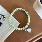 “Consider the Lillies” Handmade Glass Bead Stretch Bracelet with Flower and Mini Cross Charm
